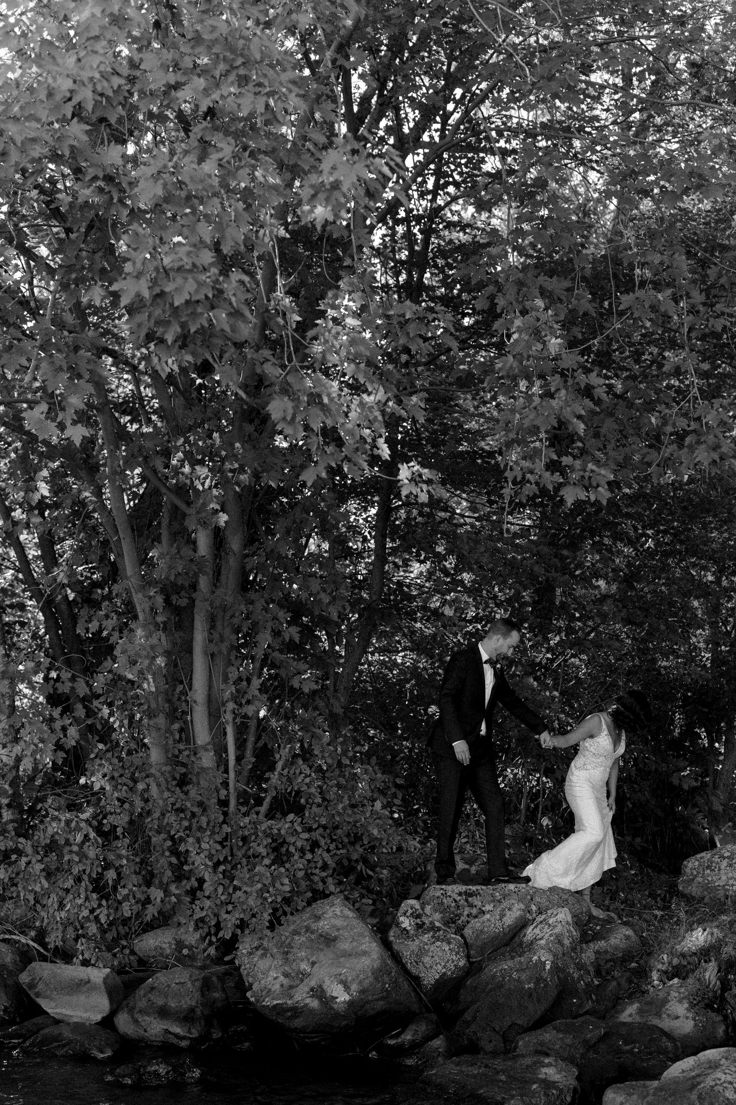 Bride and groom on the rocks in Lac-Brome after their countryside intimate wedding.
