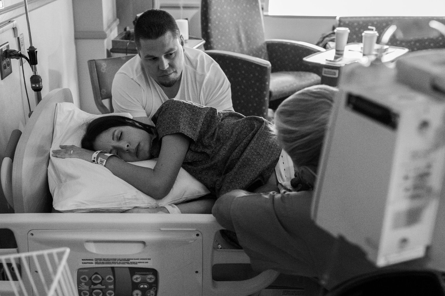 Husband supporting his wife through contractions during her birth in Lafayette Colorado