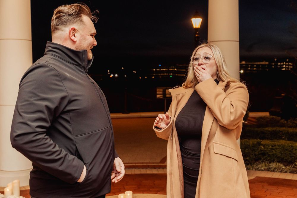 A candid moment of surprise and joy captured in an outdoor gazebo setting.