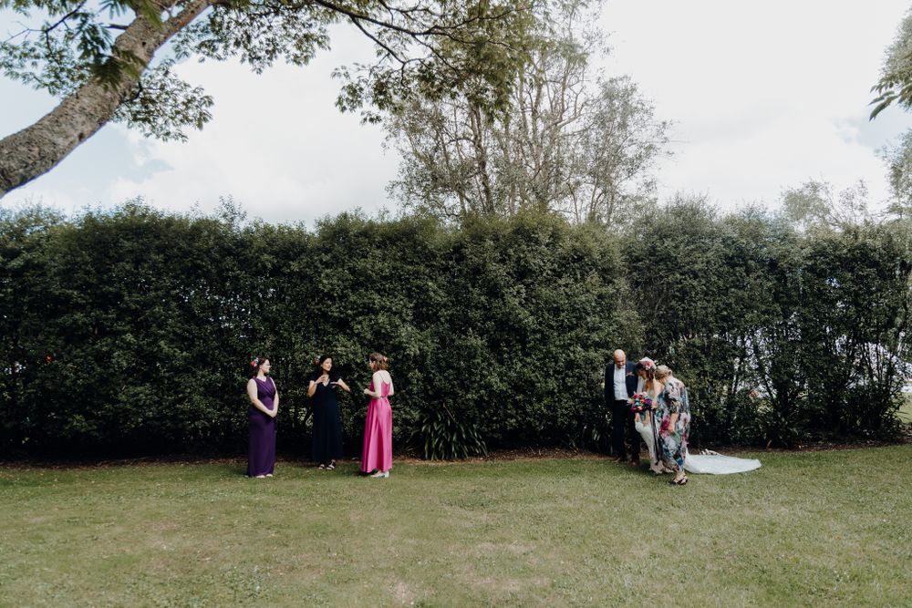 Wedding celebration in a garden setting with guests gathered on a summer day.