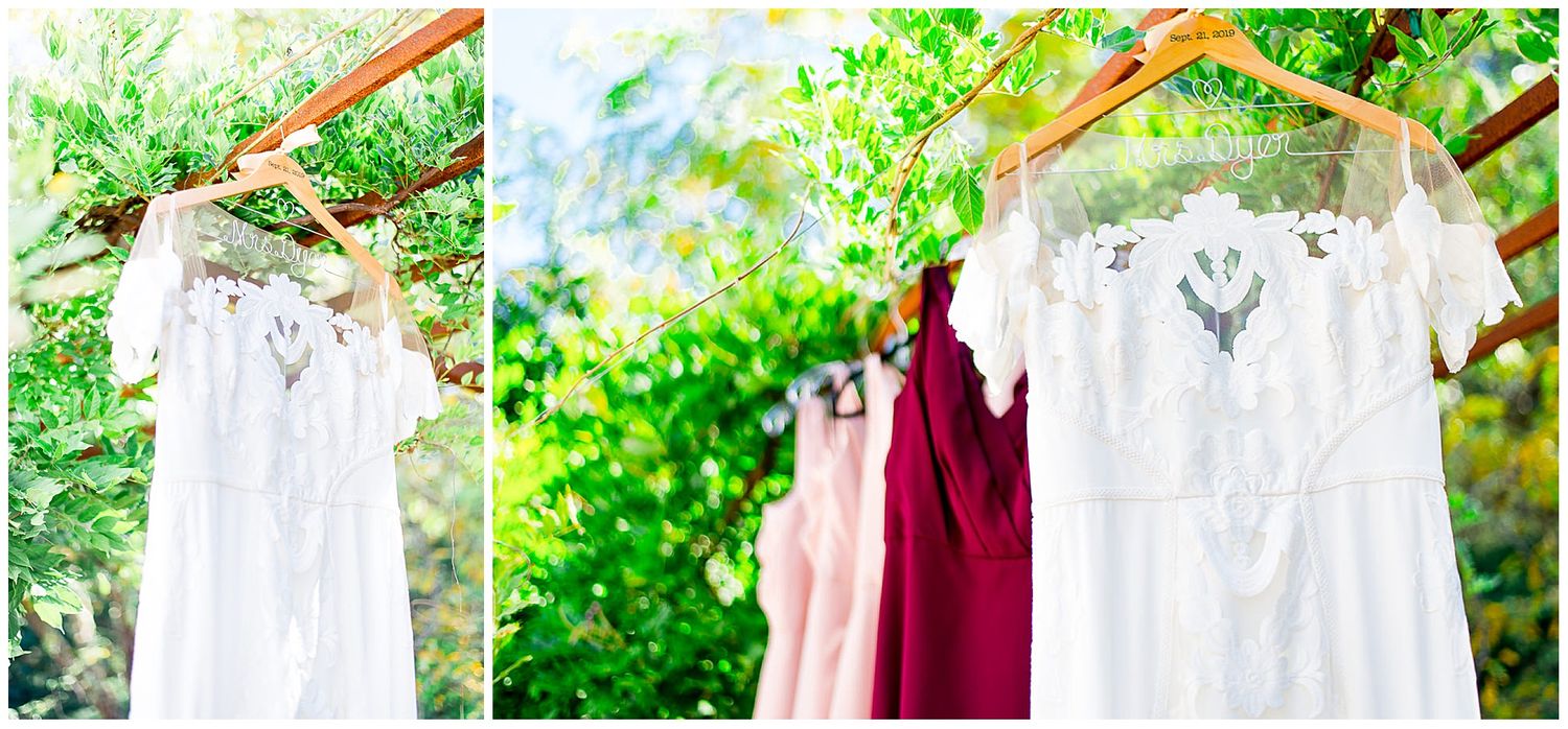 wedding dress and red and blush bridesmaids dresses hanging side by side for a fall wedding in California