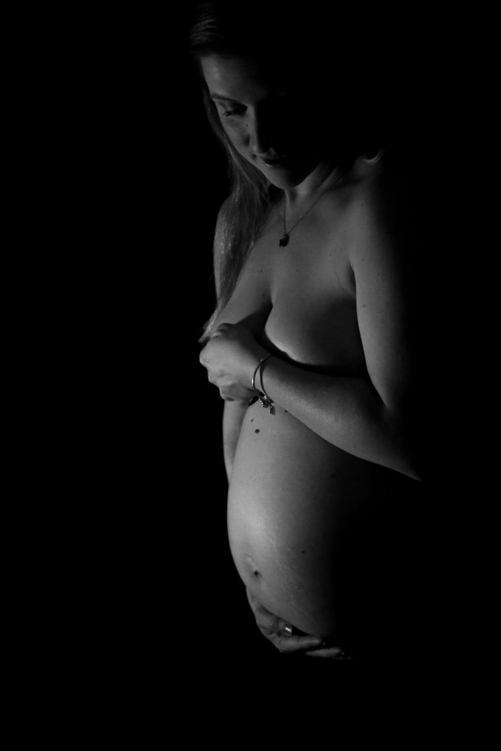 black and white maternity photo of nude woman