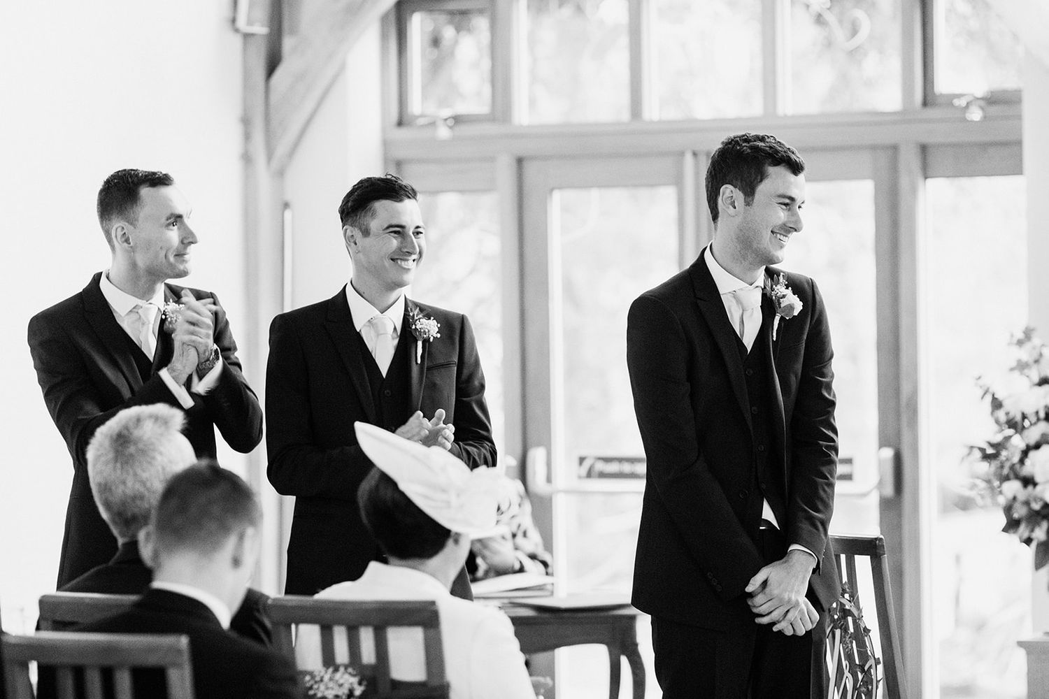 groom waiting at end of alter