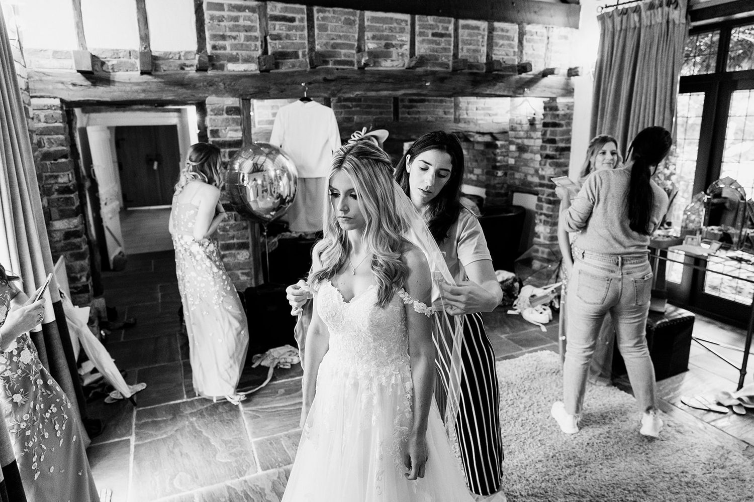 bride putting on wedding dress
