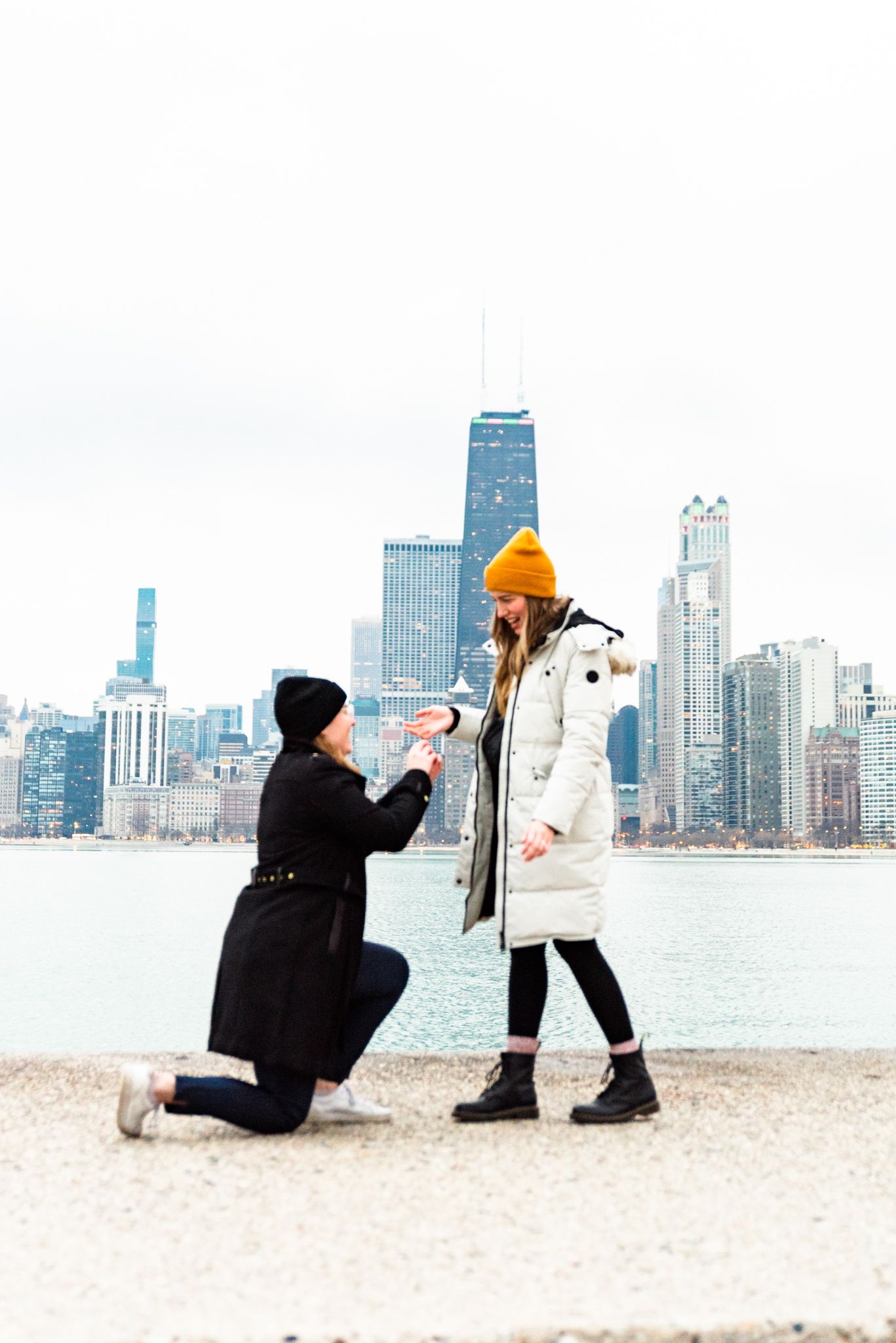 one woman on one knee proposing to girlfriend for Chicago proposal at North Avenue Beach