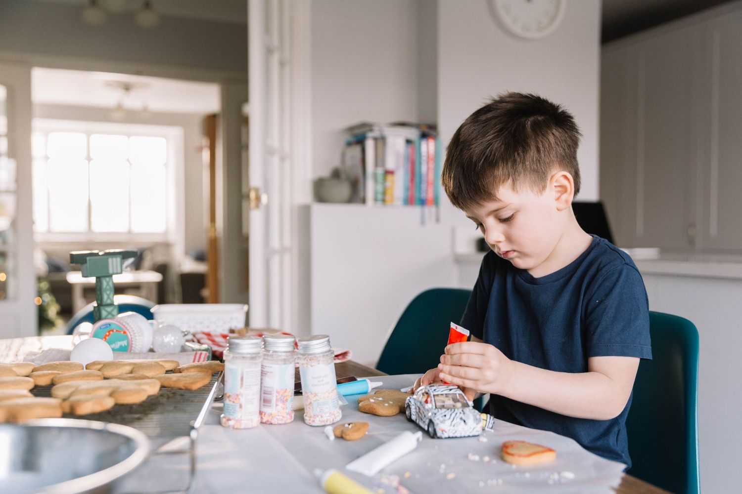 boy icing Christmas cookies