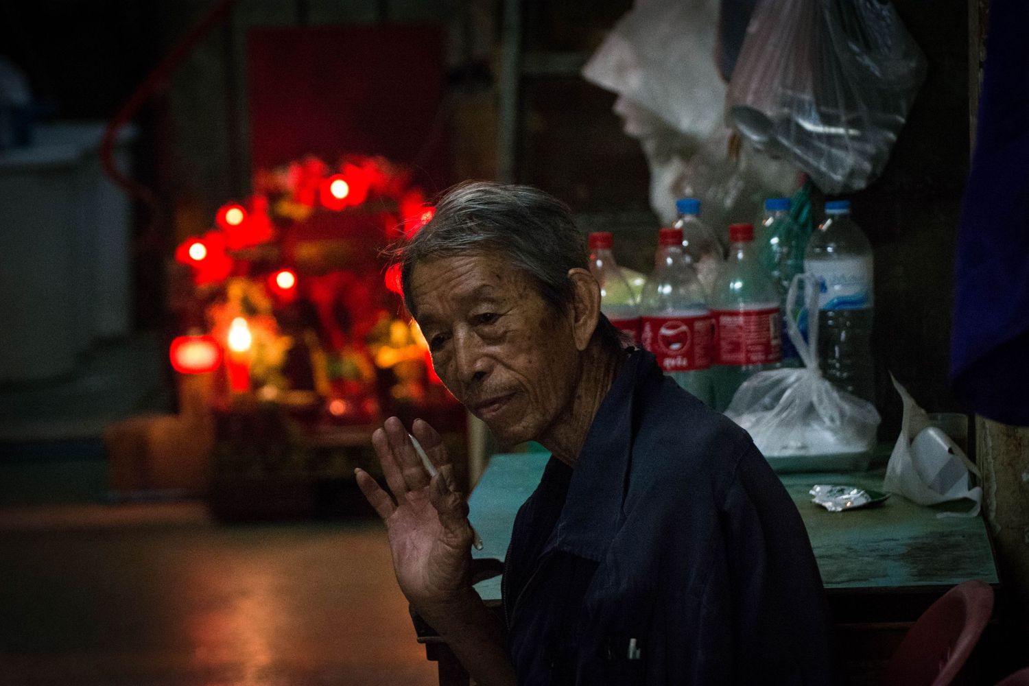 Environmental portrait of stall holder in indoor market