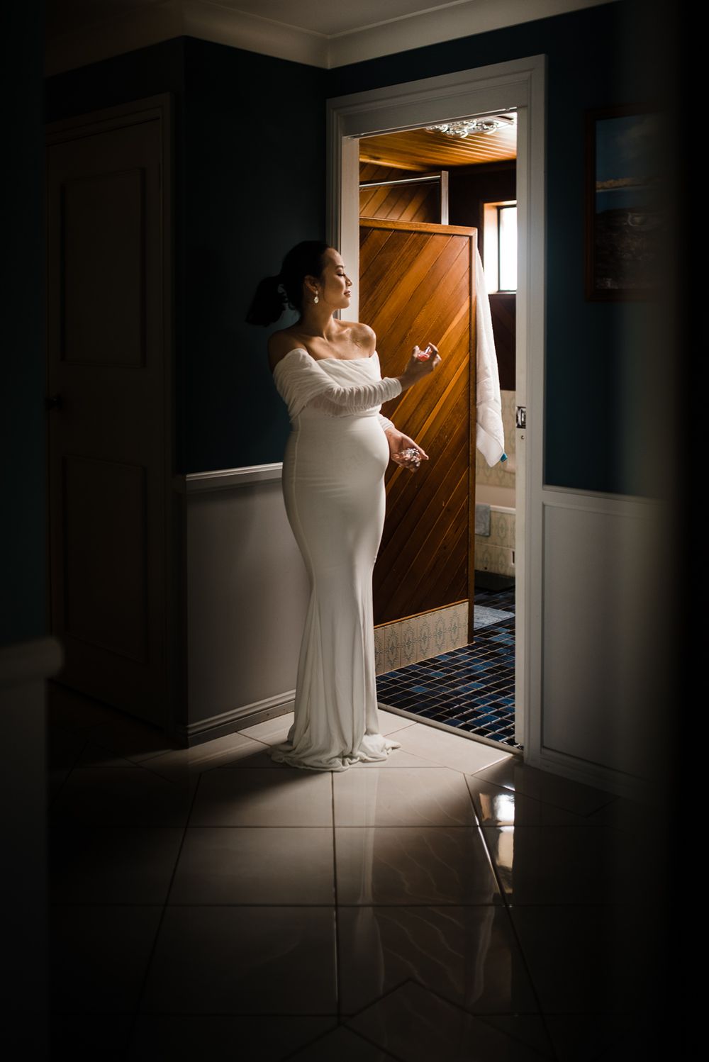 bride putting final touch to her wedding dress