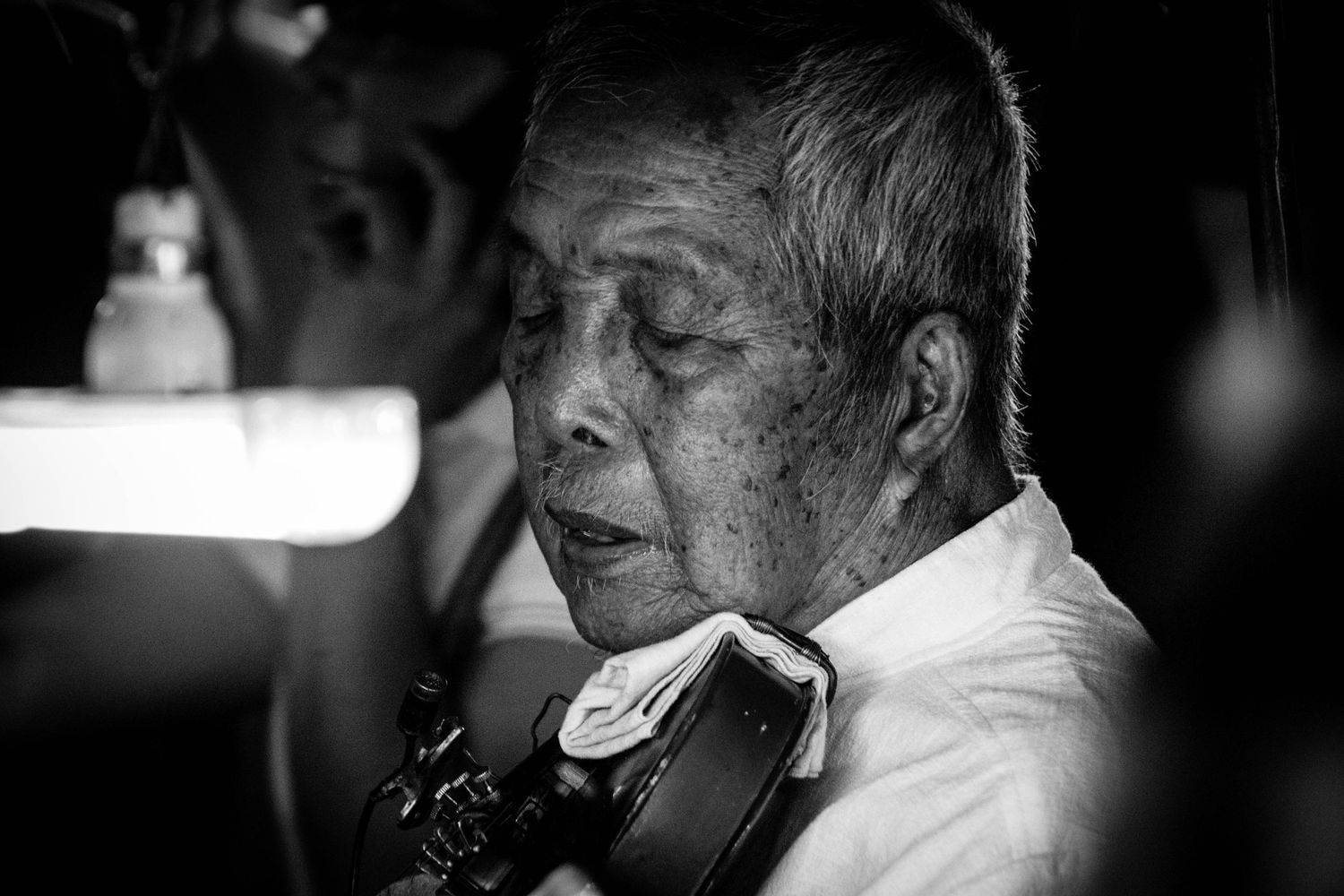 Environmental portrait of fiddle player in Chiang Mai Thailand