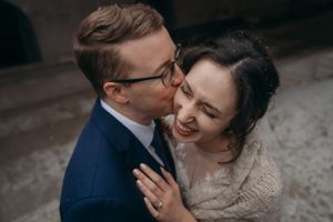 An intimate wedding portrait showing a tender moment between newlyweds.