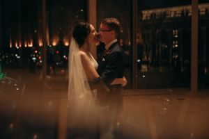 A romantic evening wedding dance captured through soft bokeh lights.