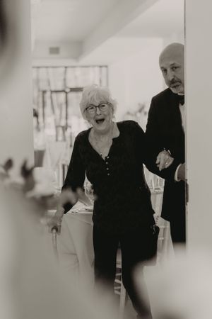 Two guests share a joyful moment at wedding celebration.