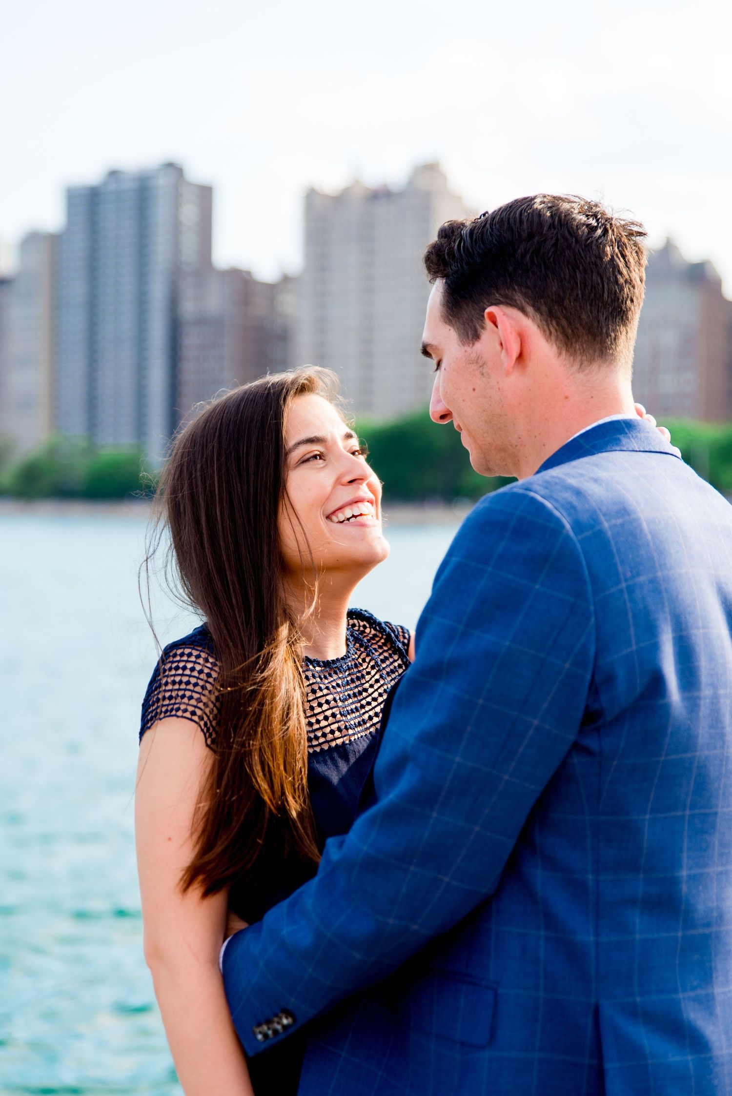 man and woman kissing in front of Hancock tower after North Avenue Beach proposal