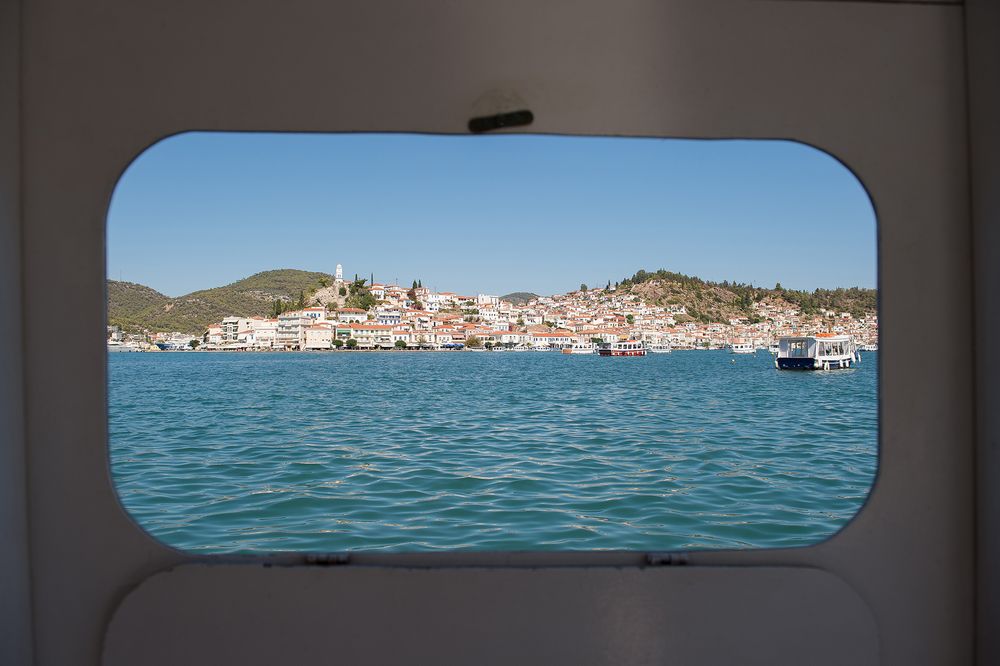 Poros island through small boat window