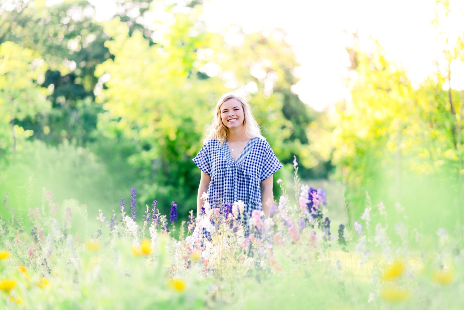 blonde woman standing in field of yellow and purple flowers at The Marmalade Lily in Ohio