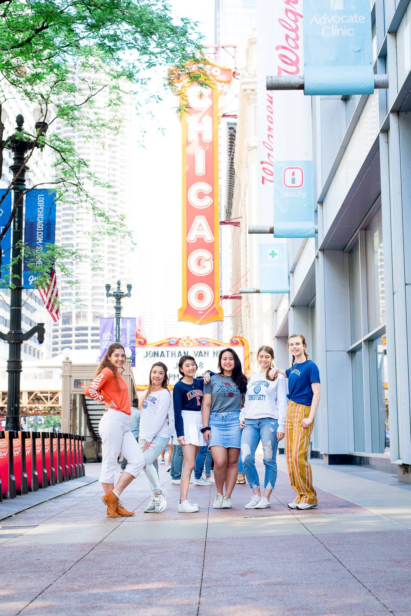 six senior girls in front of the Chicago Theater sign for Chicago senior pictures