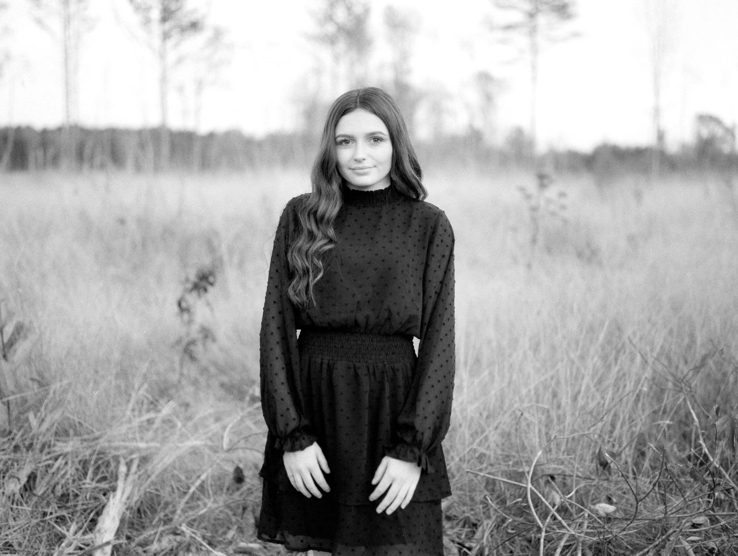 Black and white Louisiana senior portrait of female Franklinton High School student in an open field