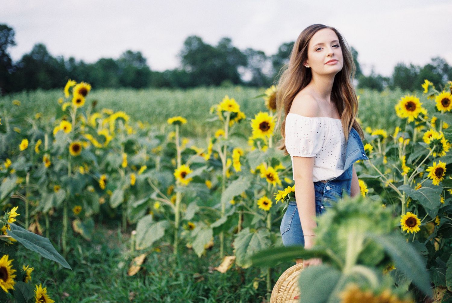Louisiana senior portraits of a female Oak Forest Academy student at a sunflower field in Picayune, Mississippi