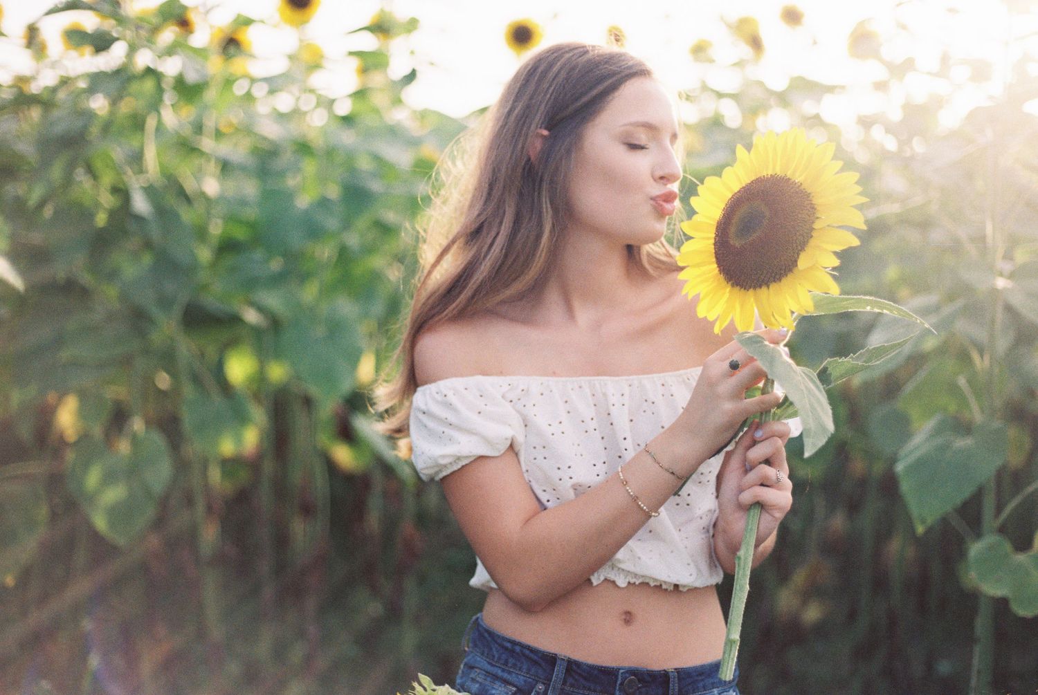 Louisiana senior portraits of a female Oak Forest Academy student at a sunflower field in Picayune, Mississippi