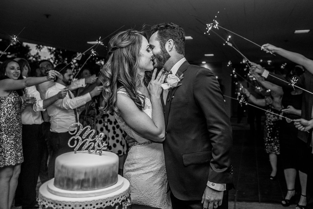 rebecca skidgel photography best second shooter ever bride and groom sparkler kiss before cake cutting