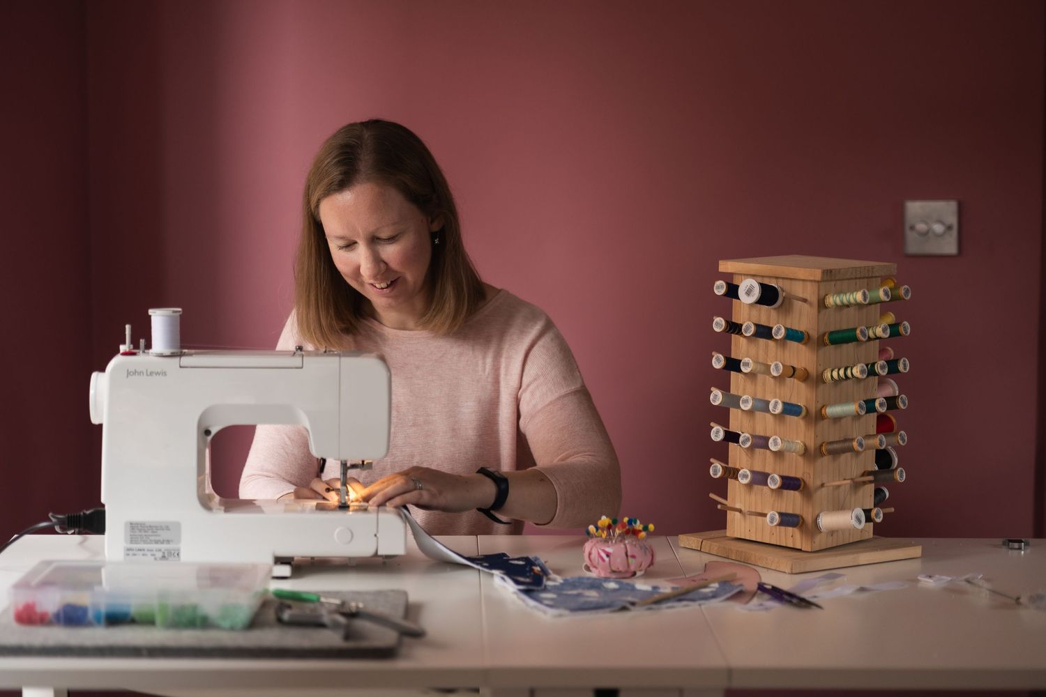 Small business owner Ruth, of Ruth's sewing studio. Natural image of her working behind her sewing machine captured.