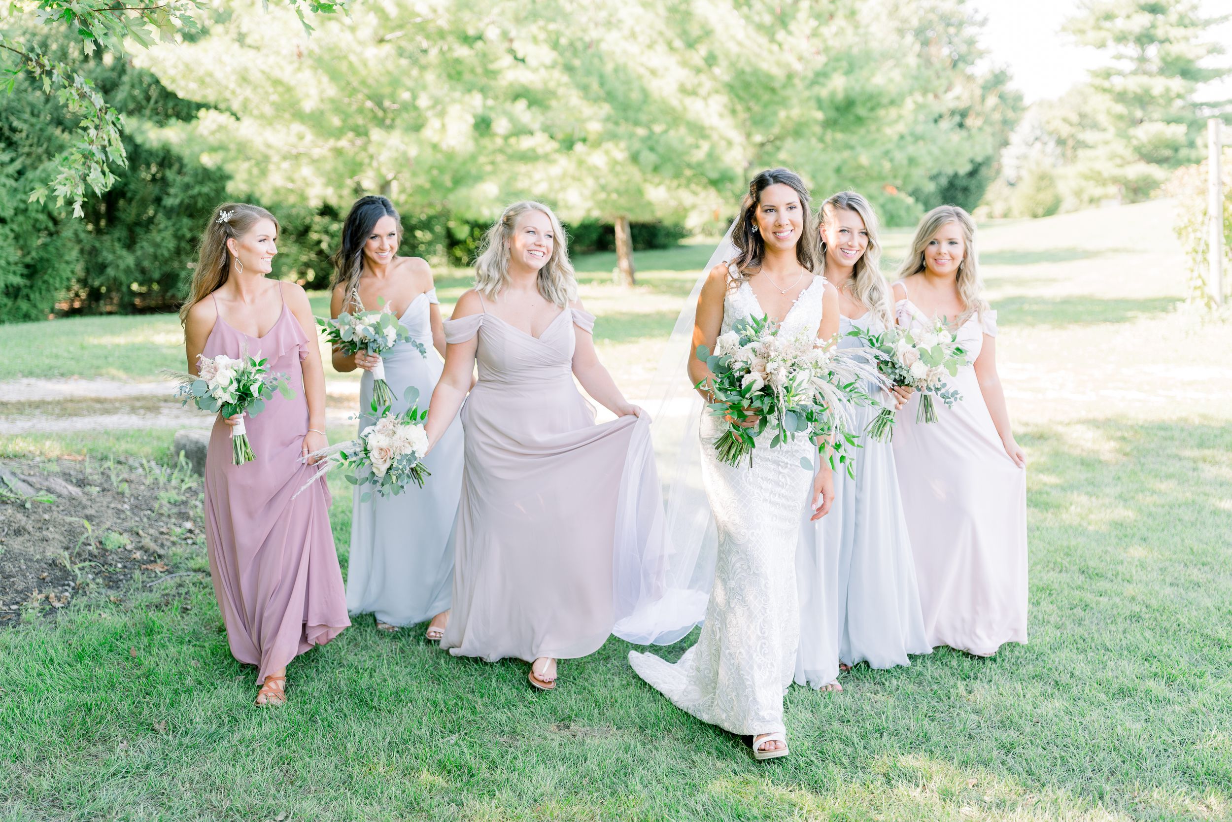 Vineyard bridal party photos with pastel dresses at Prairie Moon Winery wedding in Ames, Iowa