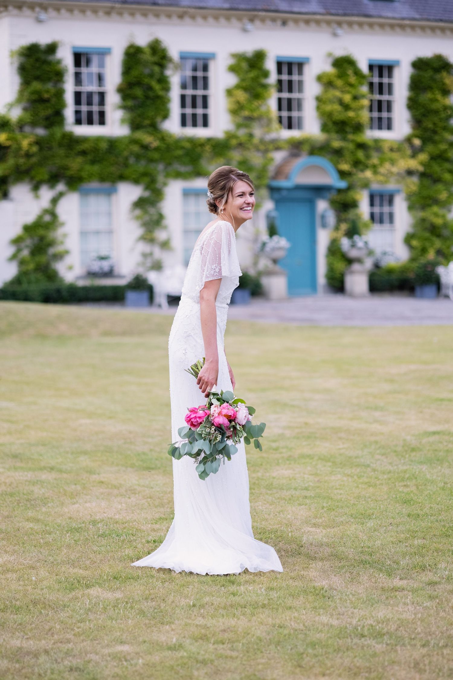 Bride laughing outside Gileston Manor
