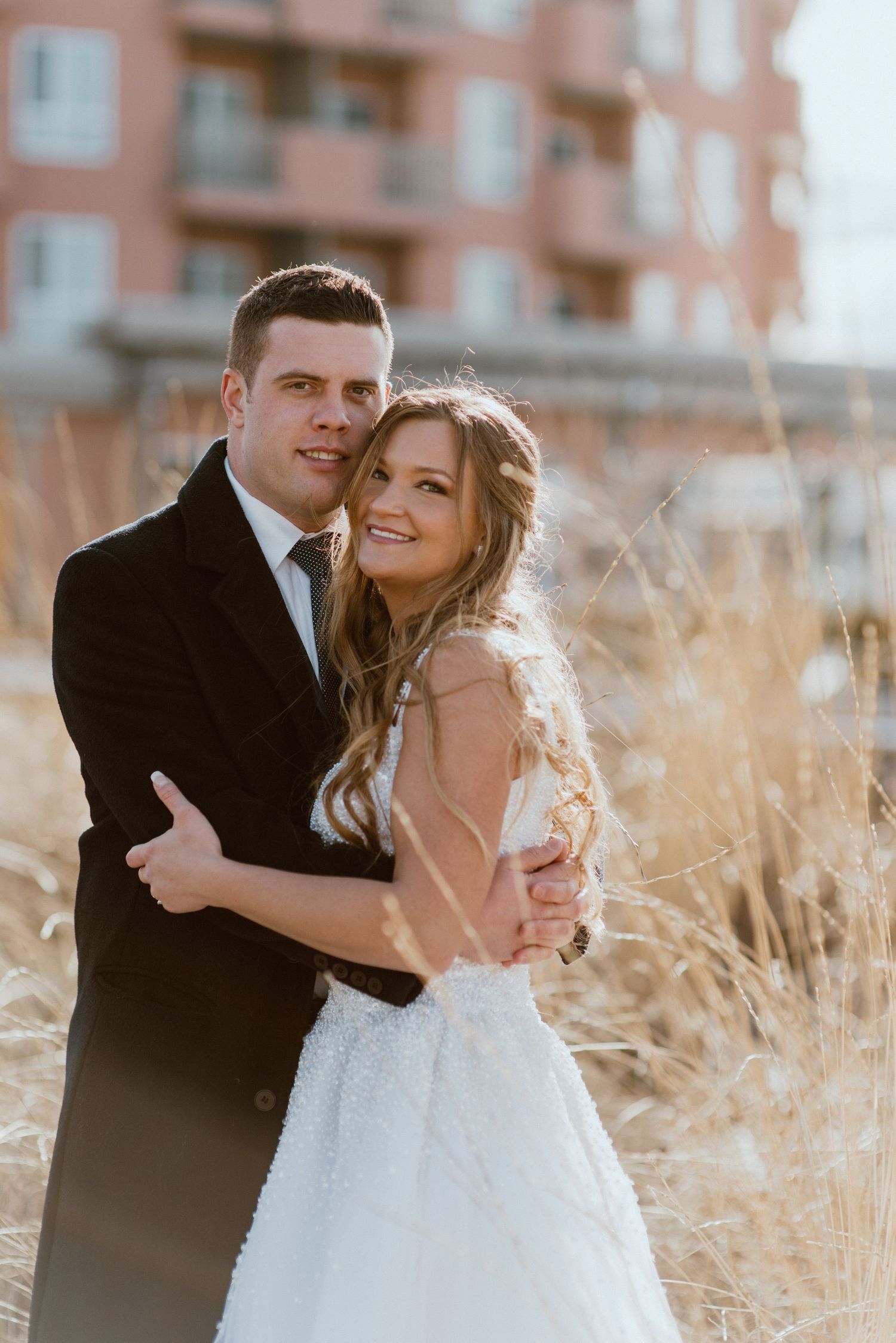 bride-and-groom-hugging-on-beach