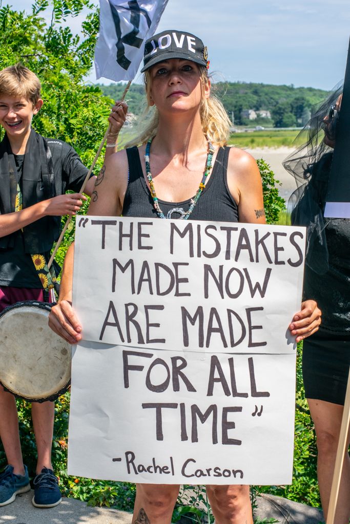 Extinction Rebellion protester holds sign that reads "The mistakes made now are made for all time".
