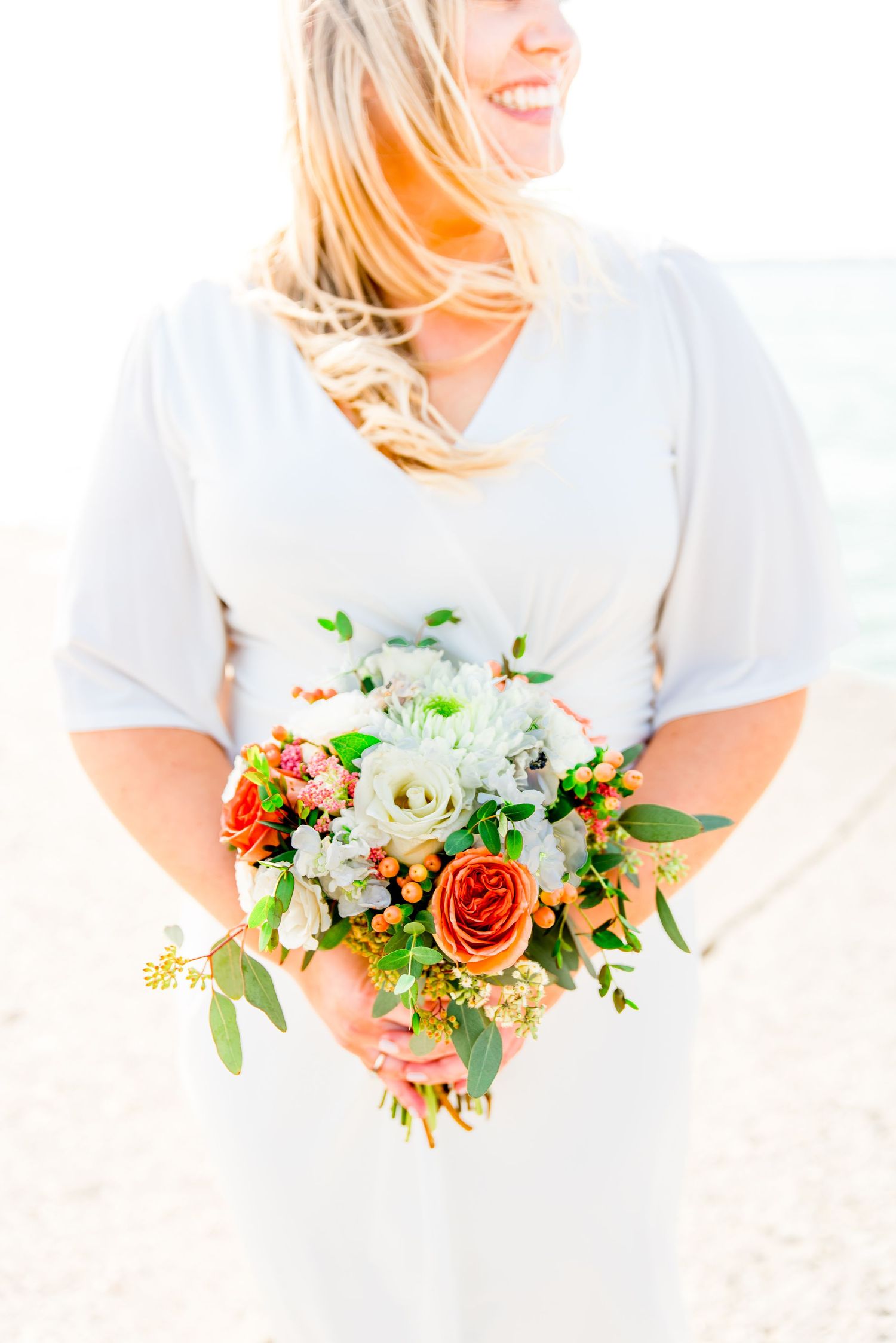 orange and white chicago elopement bouquet for north avenue beach sunrise elopement