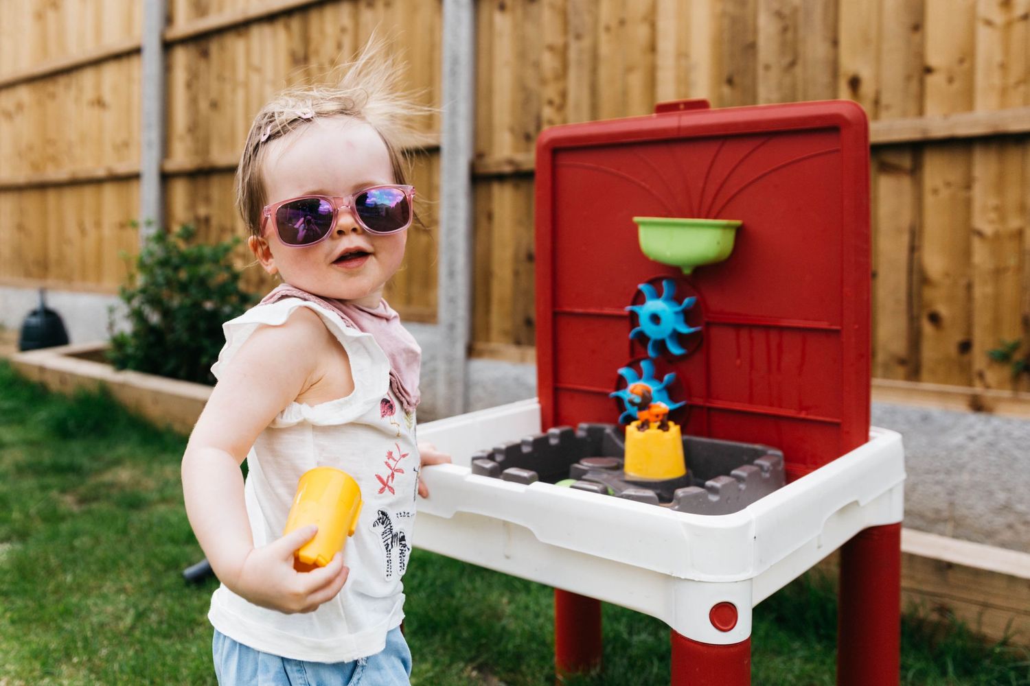 toddler girl wearing pink sunglasses