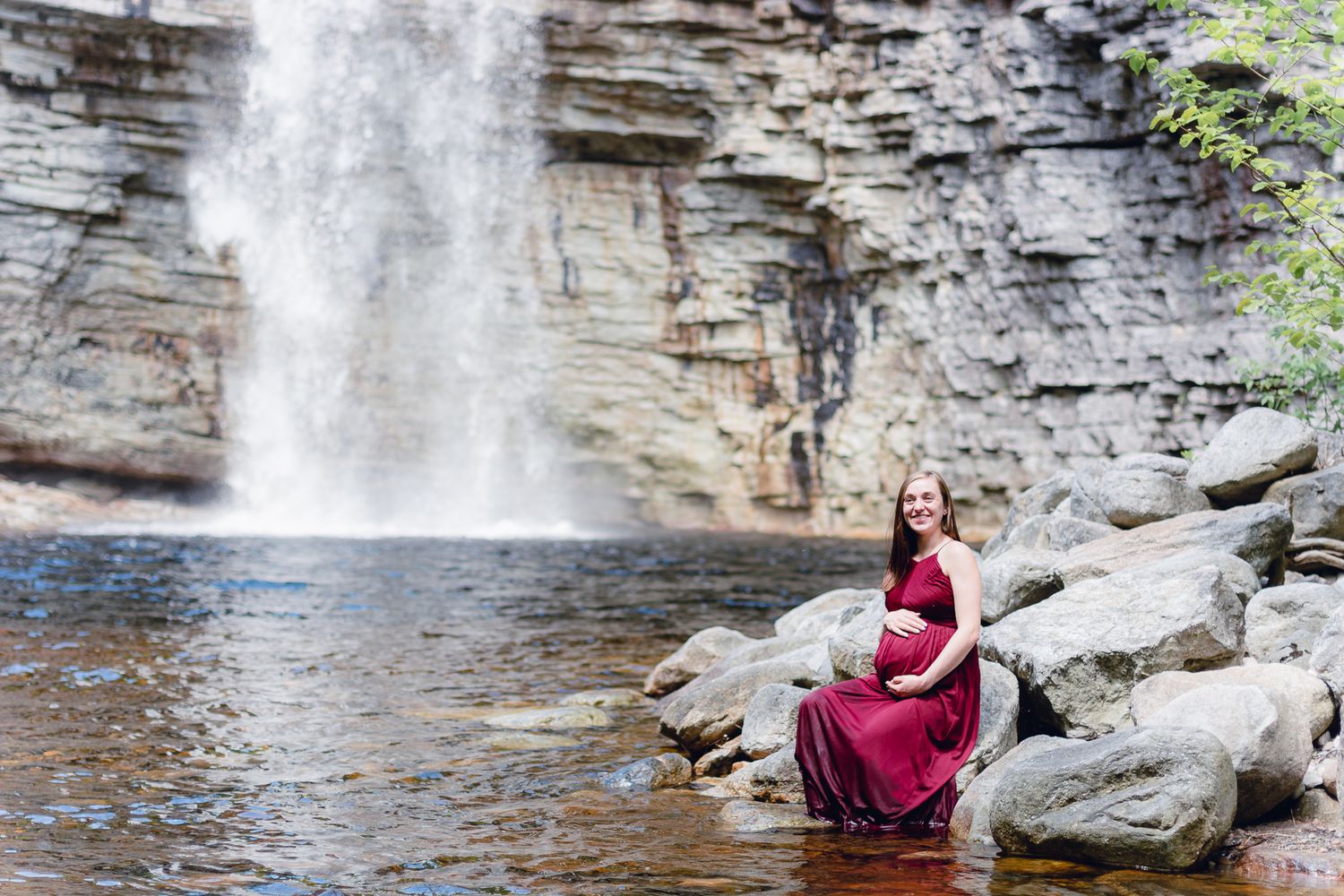pregnant woman posing in front of Awosting Falls