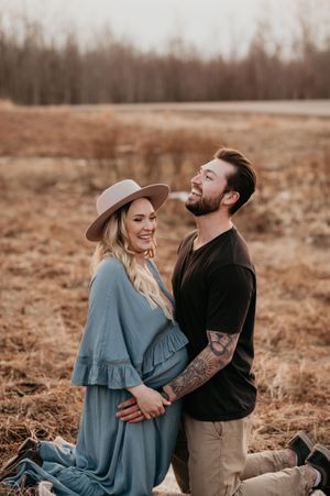 couples maternity photos in Alberta field