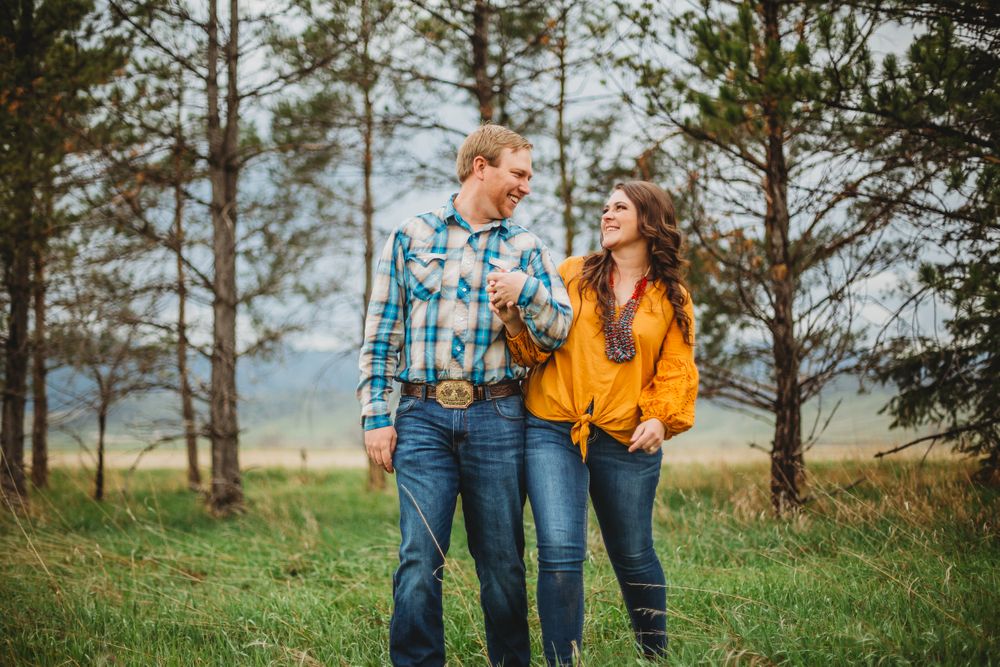 A couple gazes at eachother during their Colorado engagement session at Reservoir Ridge Natural Area in Fort Collins, CO