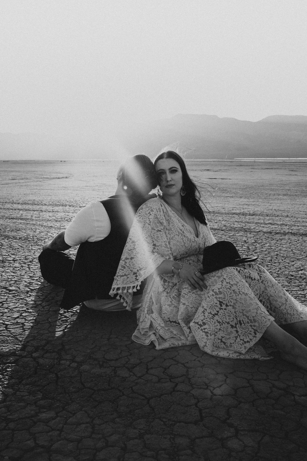 couple sitting on a dry lake bed in Las Vegas