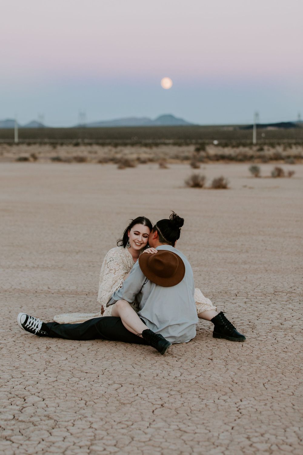 couple sitting on a dry lake bed in Nevada