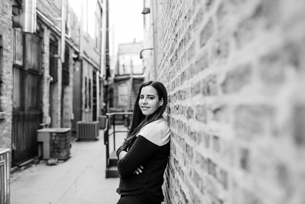woman leaning on brick wall Chicago portraits lifestyle session