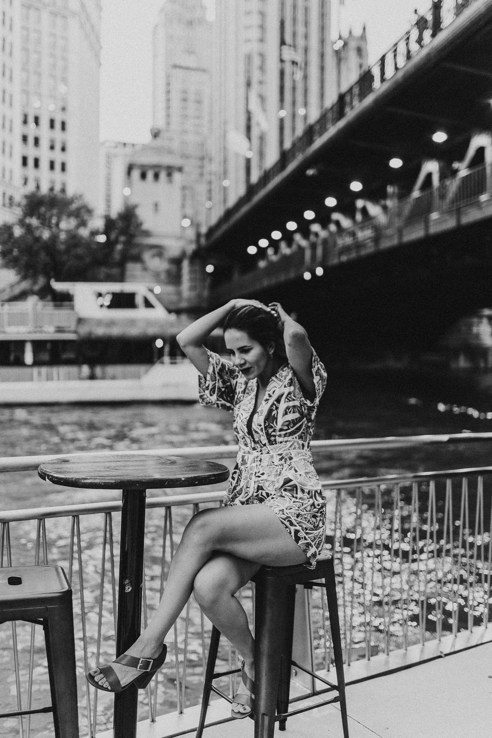 Woman sitting by Riverwalk downtown Chicago portraits lifestyle session