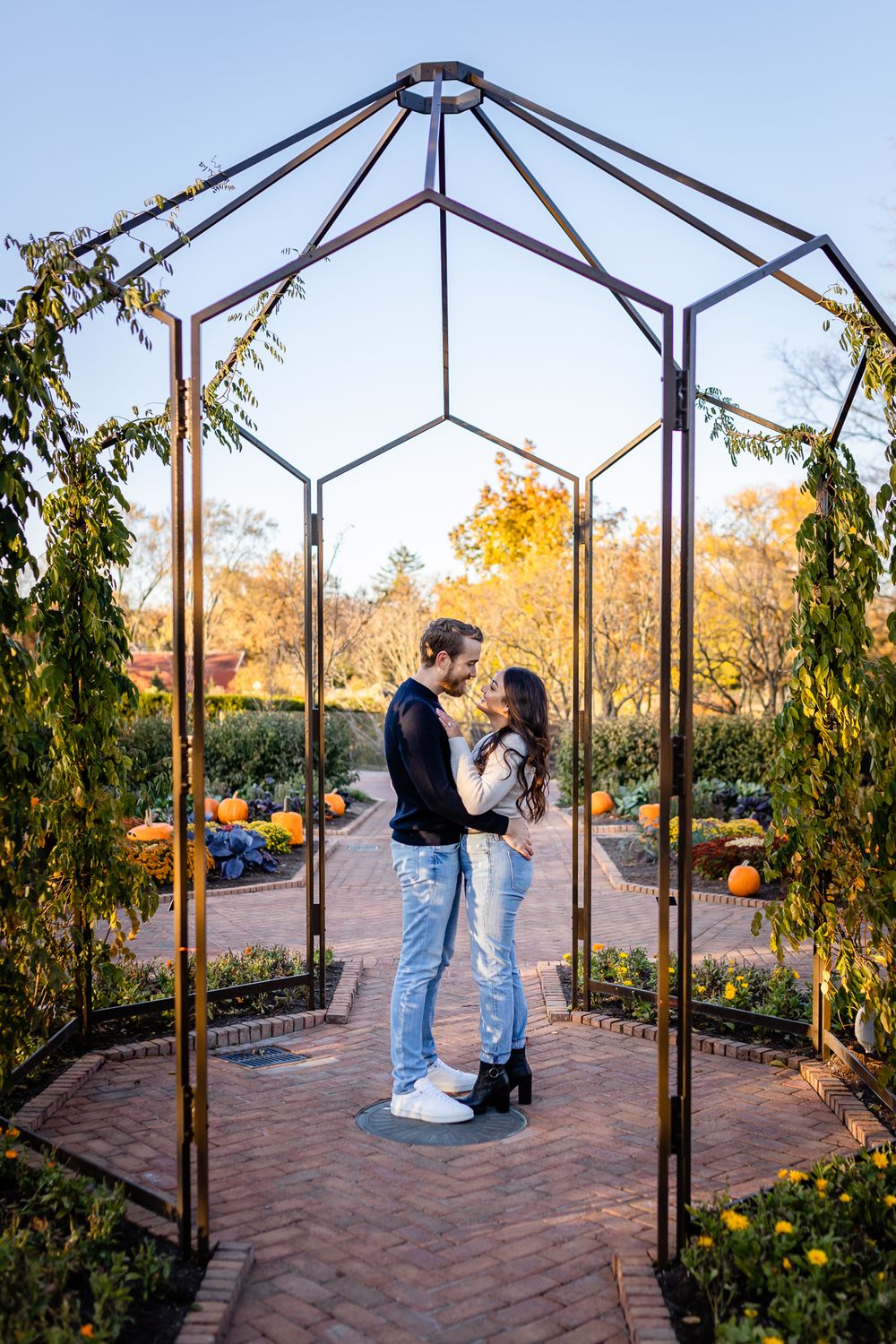couple under metal frame smiling at each other Chicago portraits lifestyle session