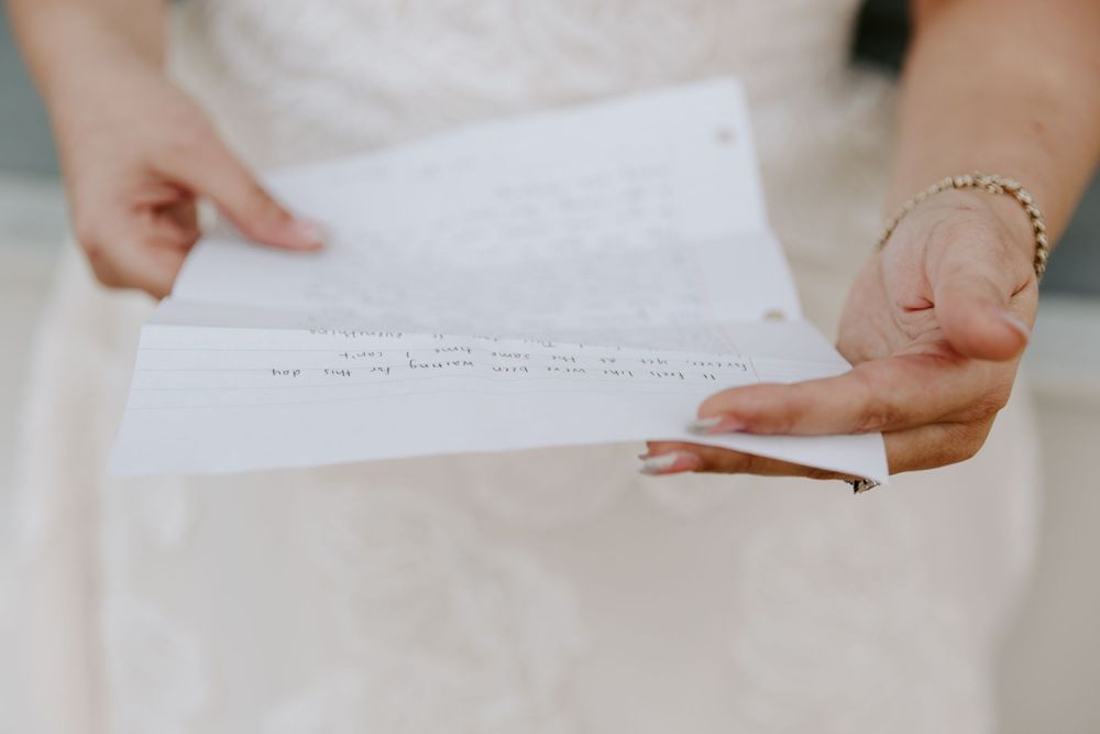 Bride reading letter to groom before the ceremony