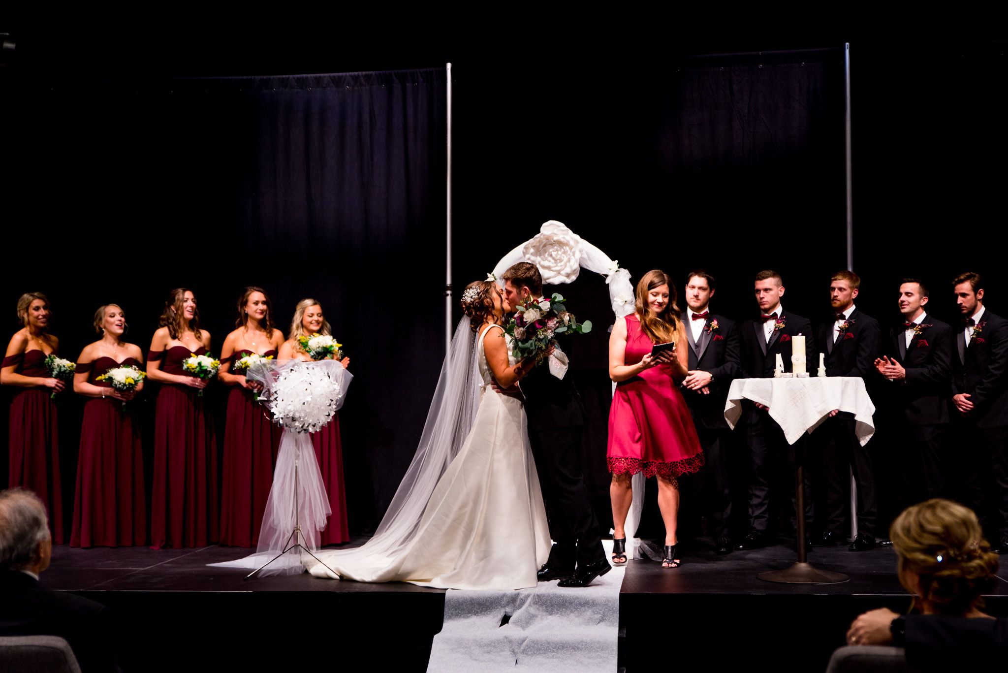 chicago bride and groom share their first kiss surrounded by wedding party