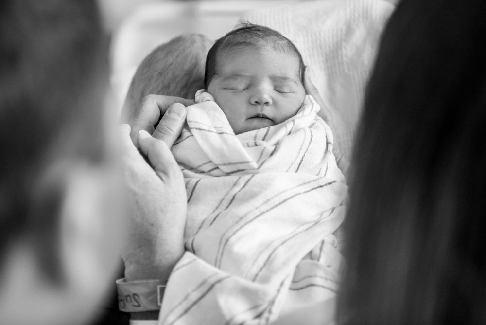 First moments with newborn baby captured in a Fresh 48 session by Heidi Harting Photography in Plymouth, MA