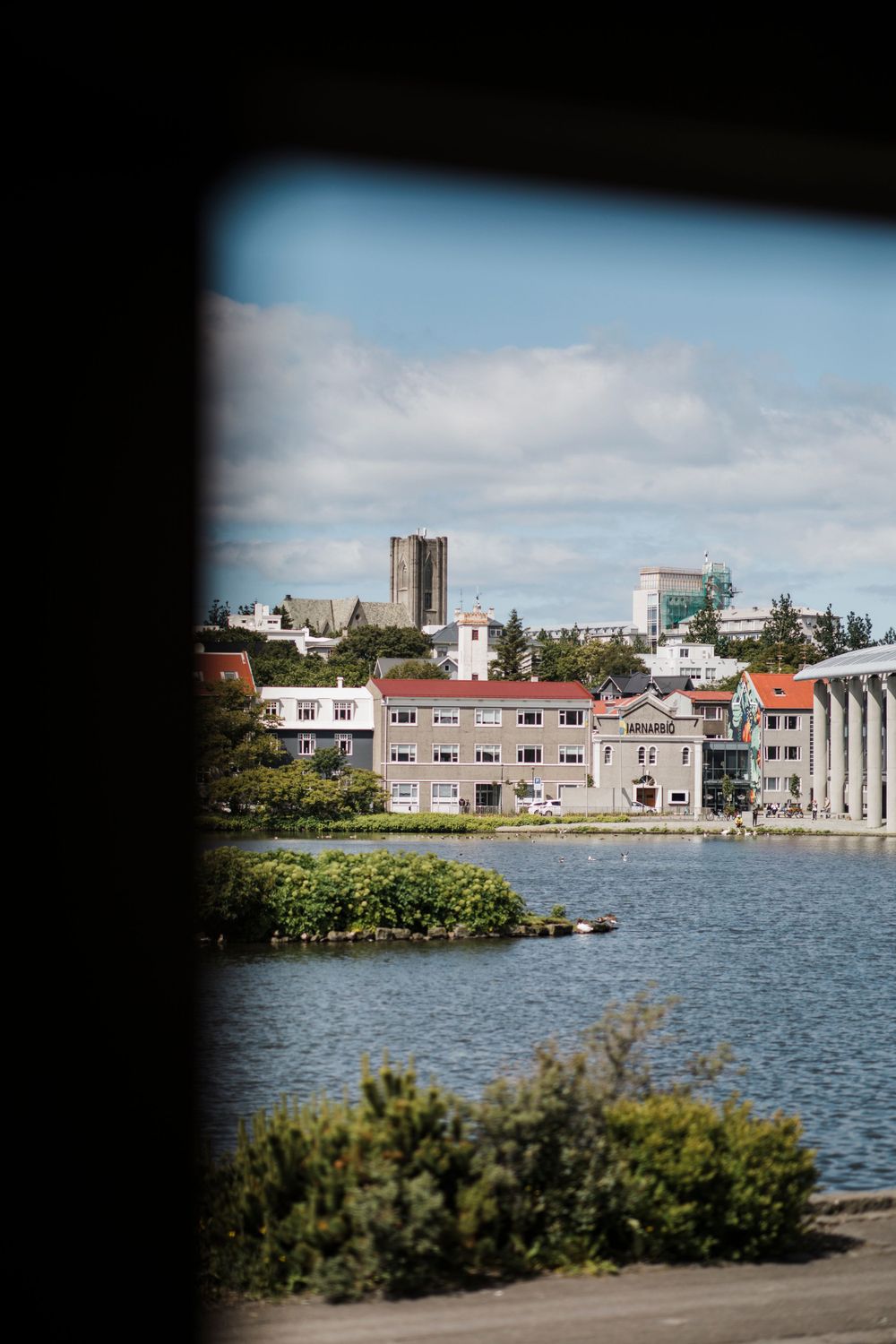 Scenic waterfront view of Reykjavik city buildings and architecture along the harbor.