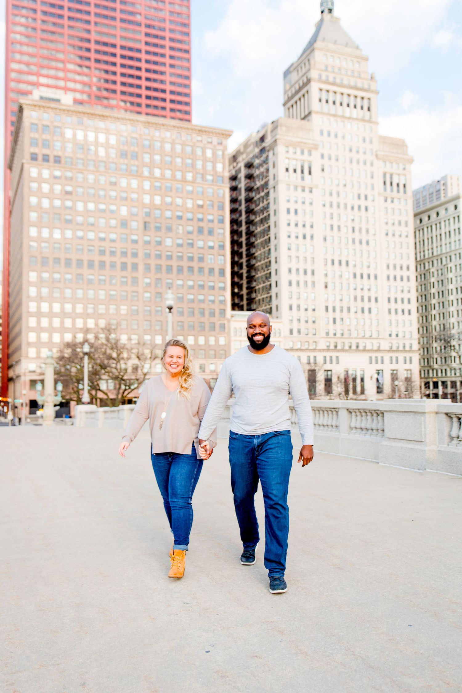 man and woman walking in front of Michigan Ave for Chicago engagement photos