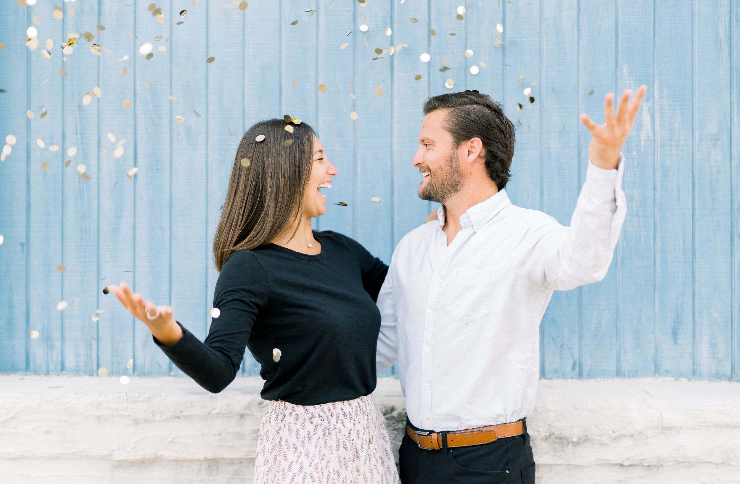 Des Moines Engagement photos in downtown Des Moines, Iowa with light and airy editing and confetti toss