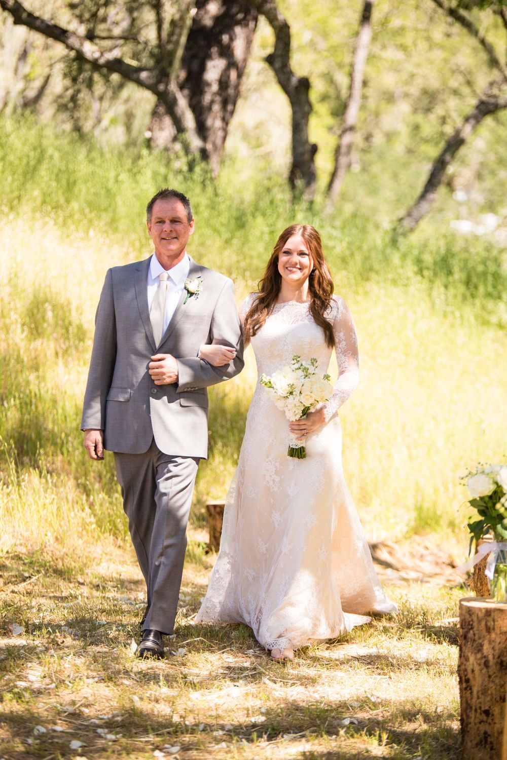 bride with her father walking down the aisle