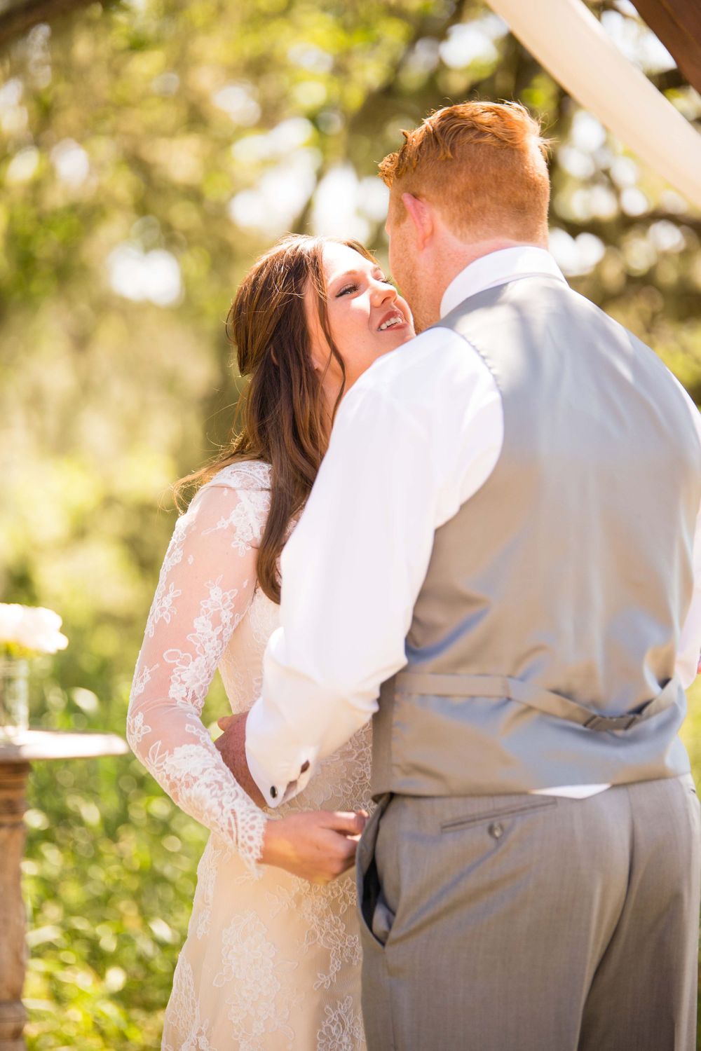 bride and groom having their first kiss