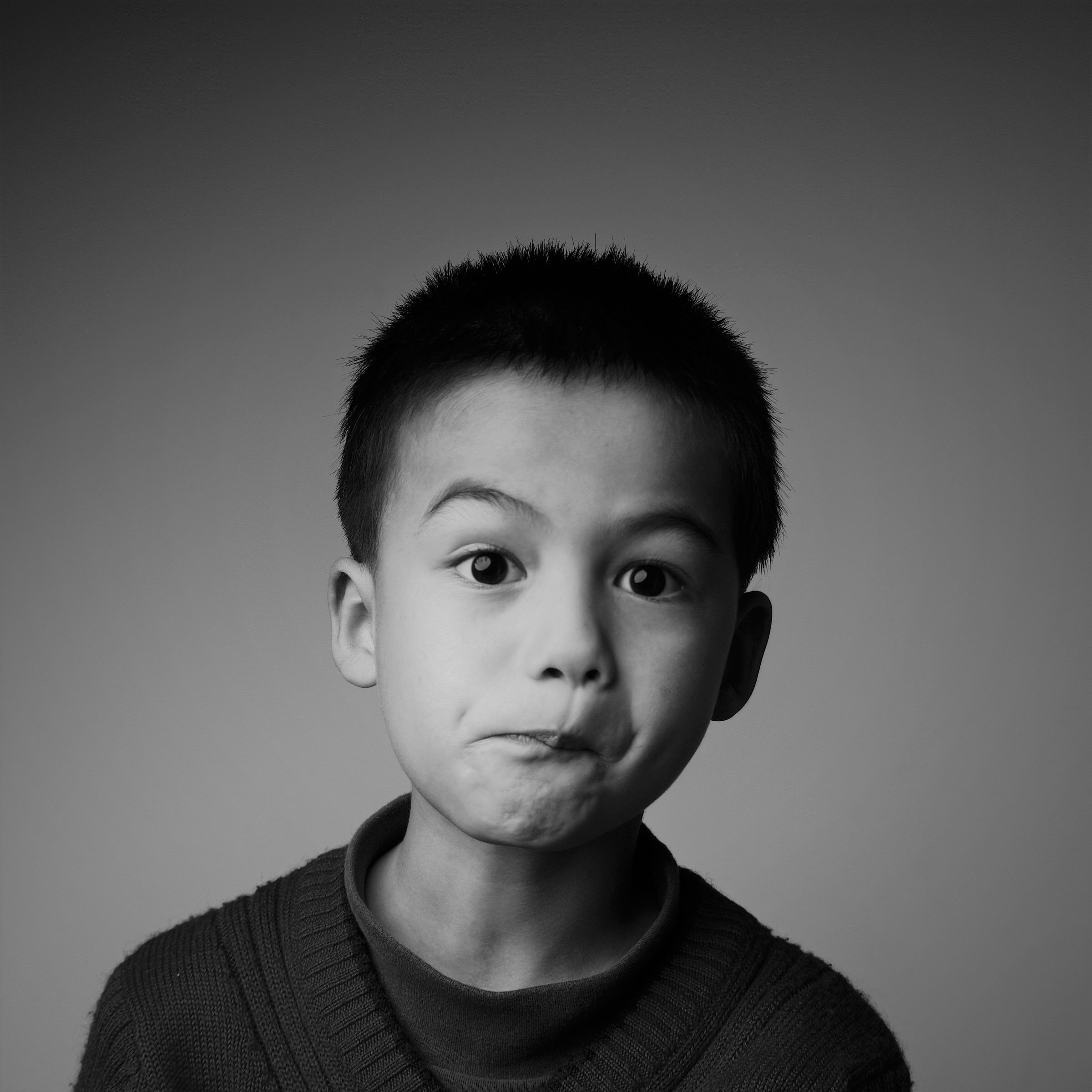 William's son Grayson pulling a funny sideways smile black and white photo