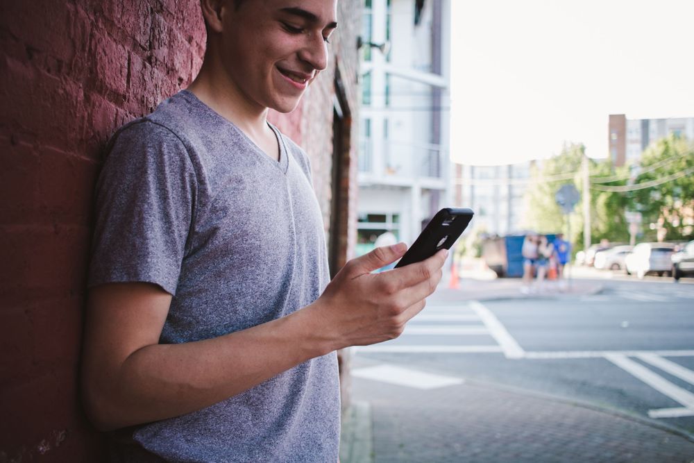 Young man texting on his phone