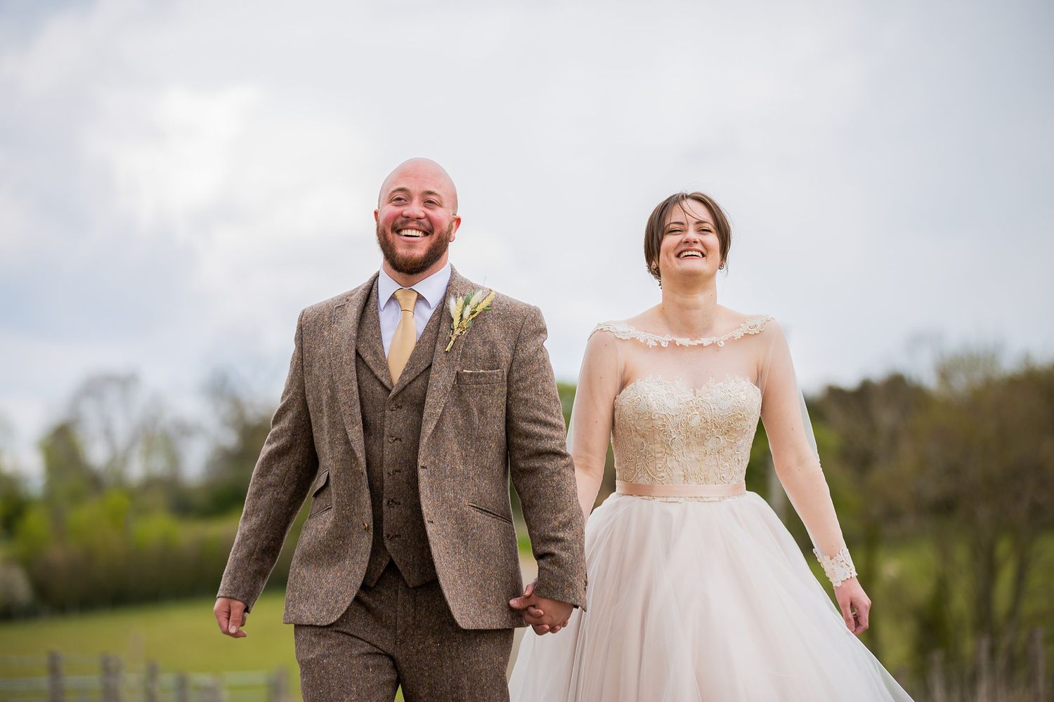 Bride and Groom walking and smiling towards camera